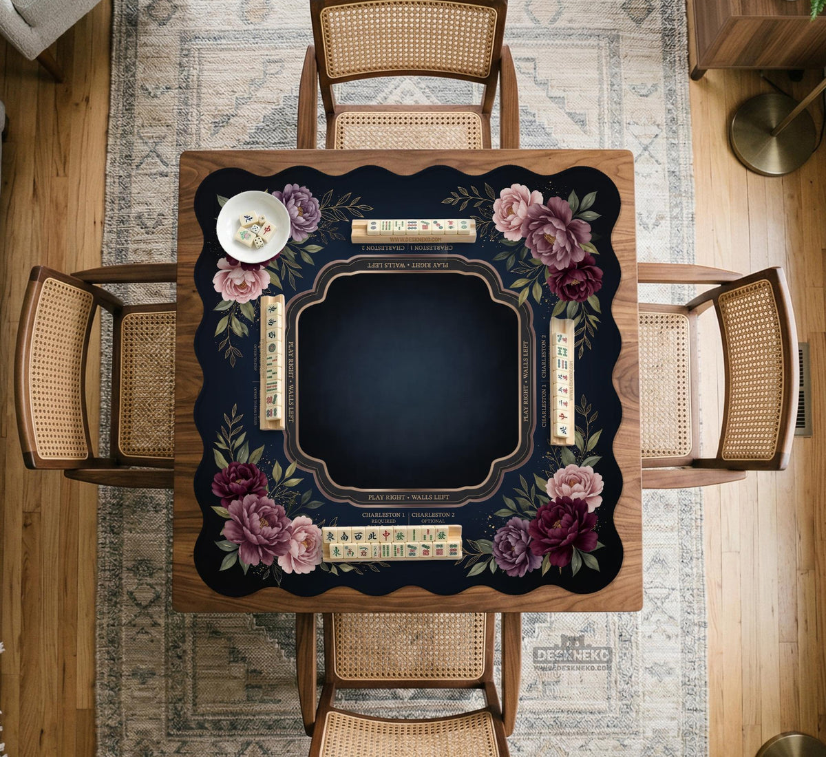 Burgundy mahjong mat with a floral border, gold botanical details, and printed American Mahjong rules on a dark background.