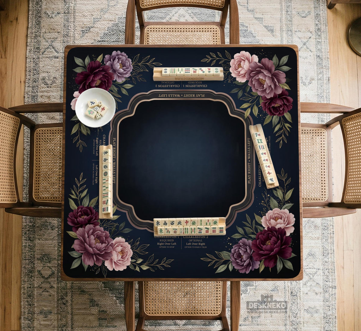 Burgundy mahjong mat with a floral border, gold botanical details, and printed American Mahjong rules on a dark background.
