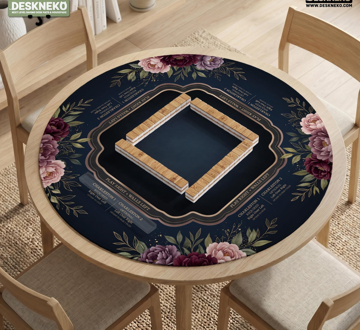 Burgundy mahjong mat with a floral border, gold botanical details, and printed American Mahjong rules on a dark background.