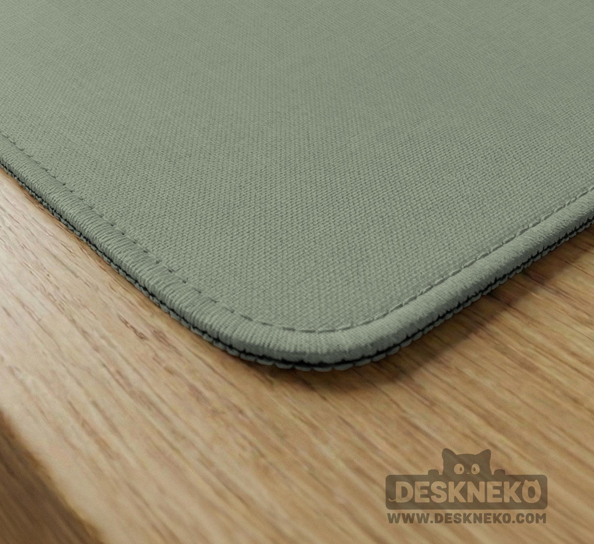 A square sage green mahjong mat with scalloped edges on a plain background.