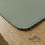A square sage green mahjong mat with scalloped edges on a plain background.