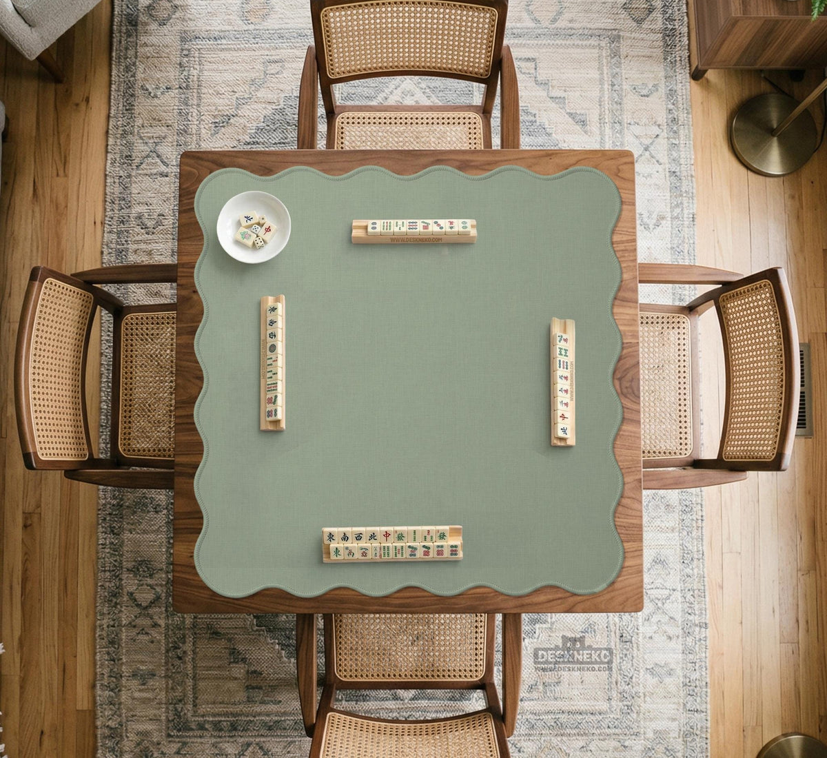 A square sage green mahjong mat with scalloped edges on a plain background.