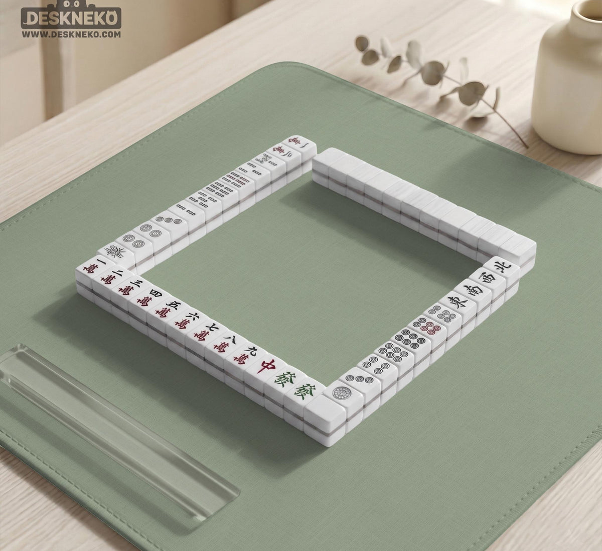 A square sage green mahjong mat with scalloped edges on a plain background.