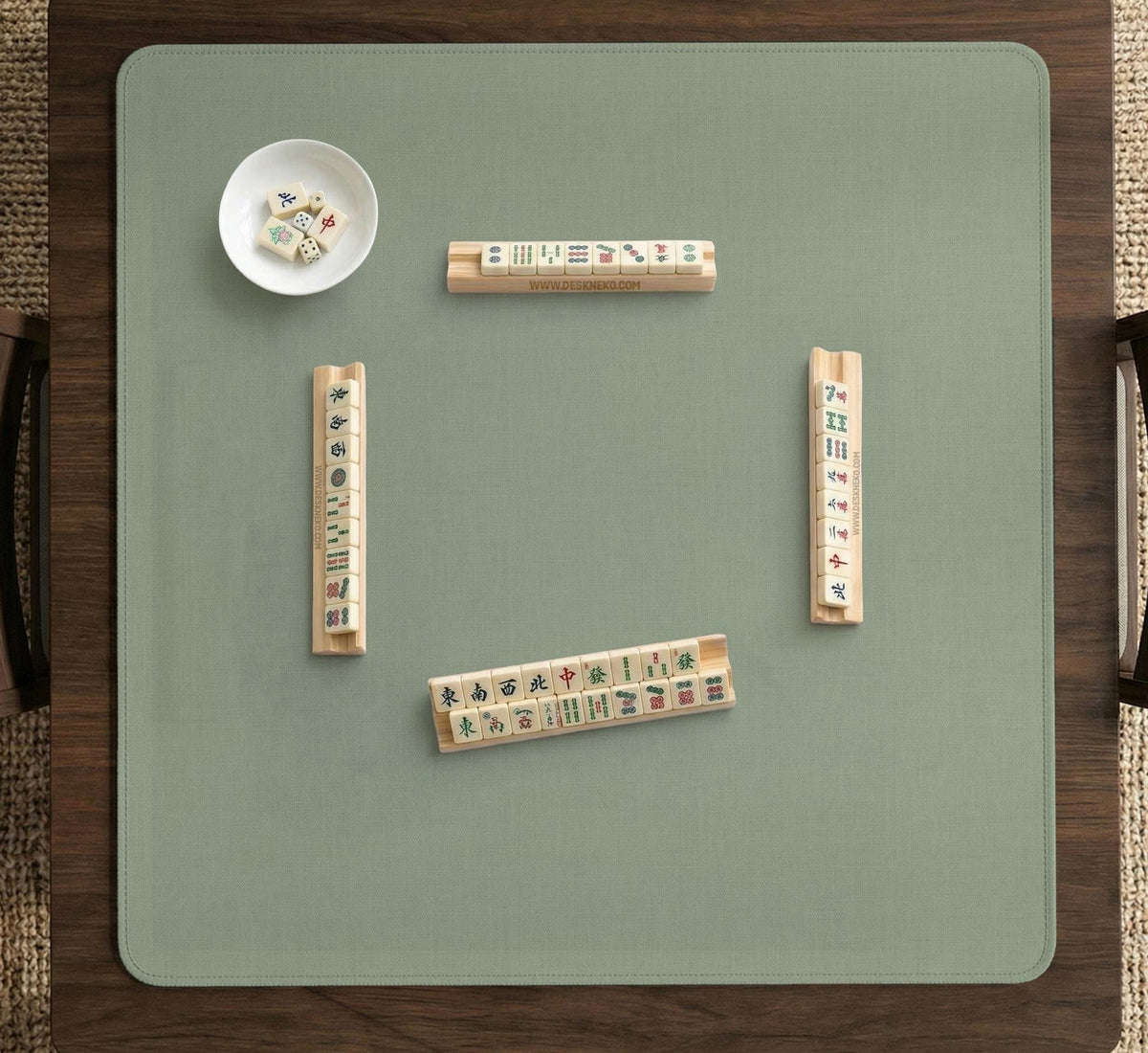 A square sage green mahjong mat with scalloped edges on a plain background.