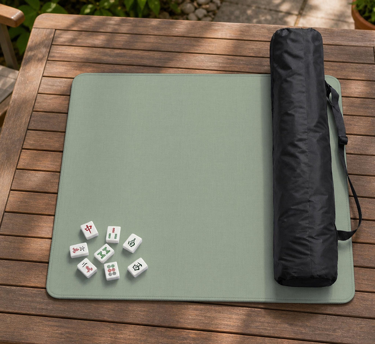 A square sage green mahjong mat with scalloped edges on a plain background.
