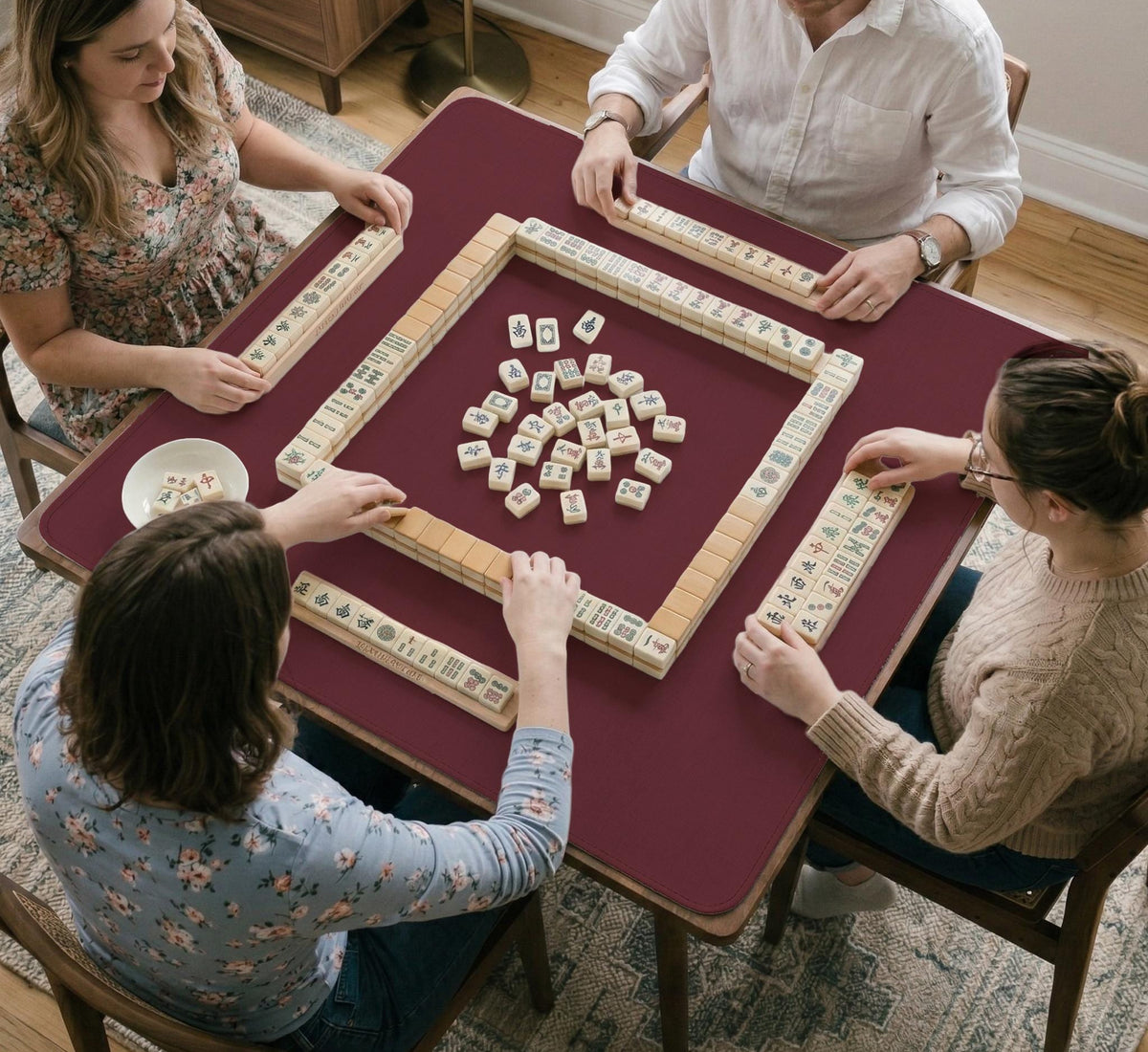 Plain burgundy square mahjong mat with scalloped edges on a white background.