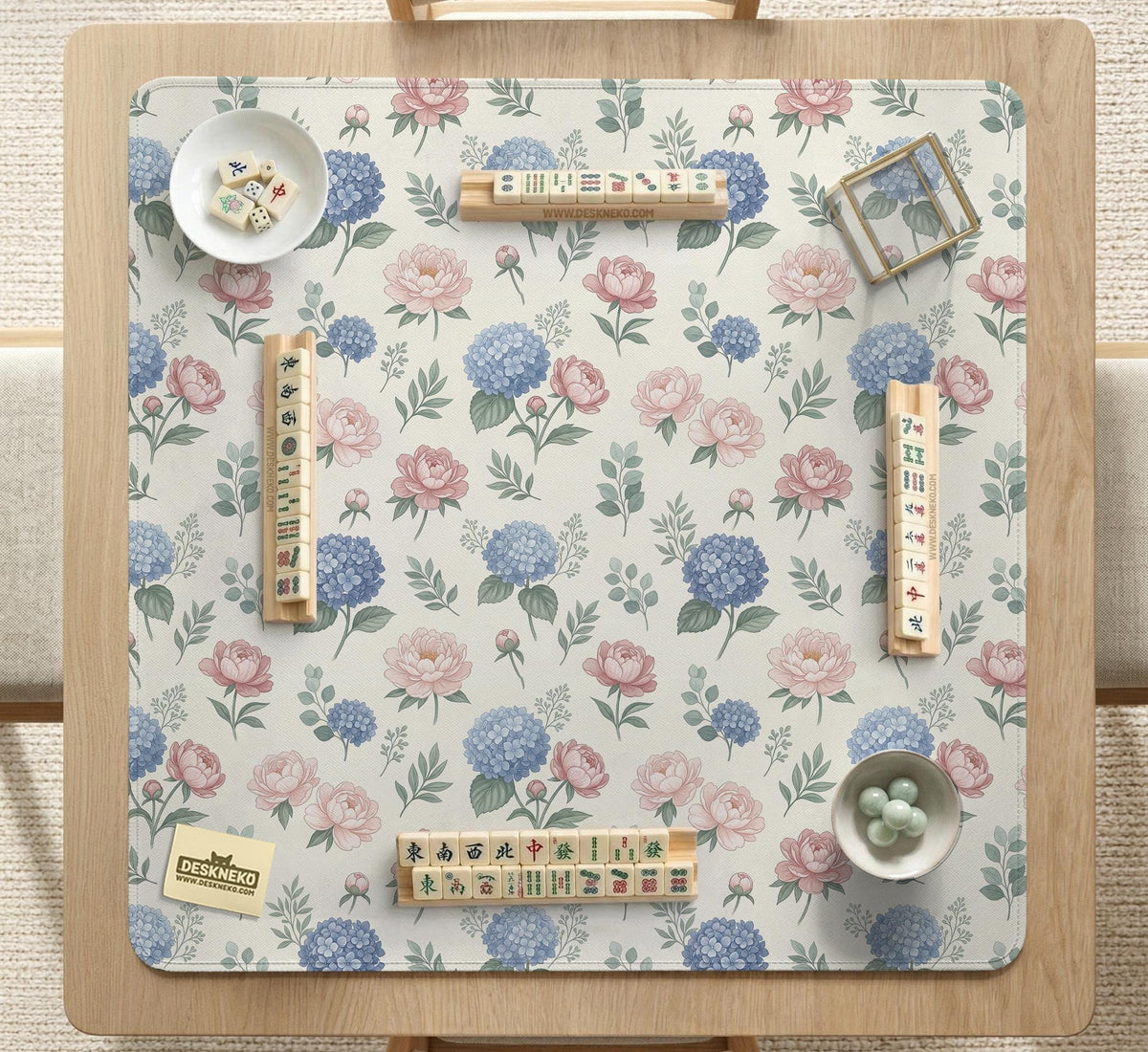 Pink floral mahjong table mat with peonies, blue hydrangeas, sage green leaves, and an ivory background.