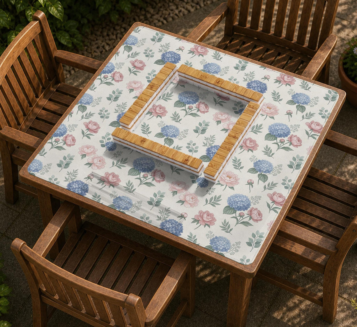 Pink floral mahjong table mat with peonies, blue hydrangeas, sage green leaves, and an ivory background.