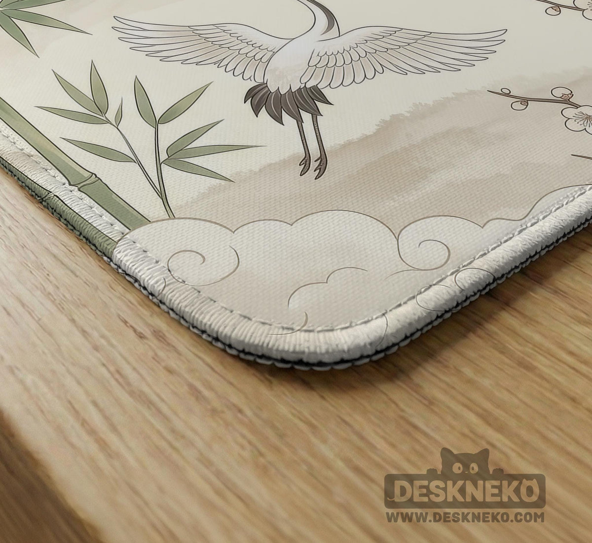 Sage green scalloped mahjong mat with bamboo, crane, and blossom illustration and printed rules around the border.