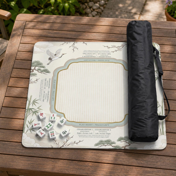 Sage green scalloped mahjong mat with bamboo, crane, and blossom illustration and printed rules around the border.
