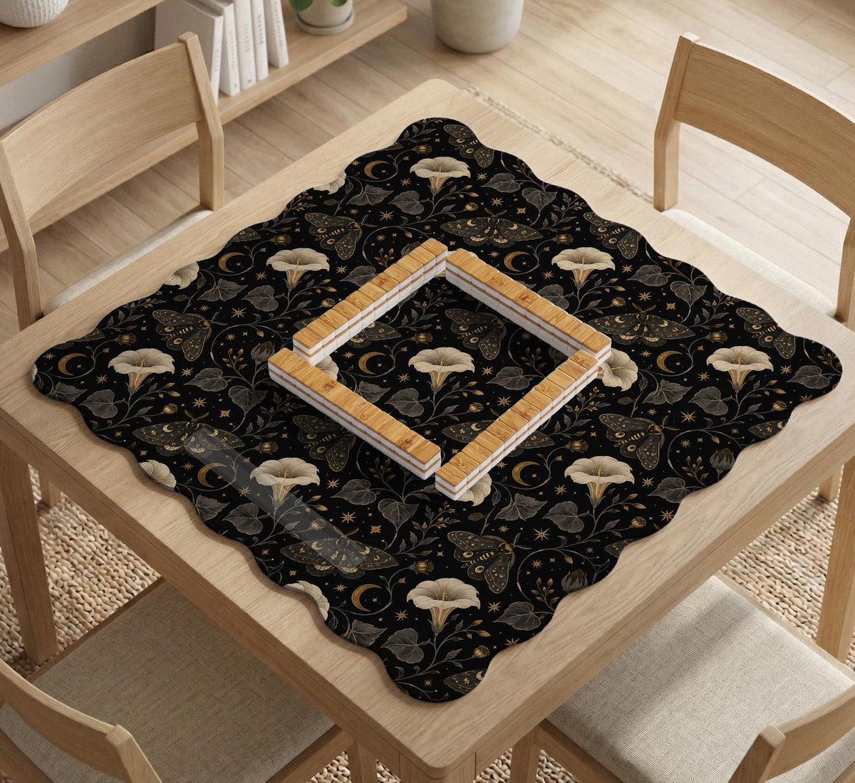 Black square mahjong mat with moths, moonflowers, crescent moons, and scattered stars in a celestial floral pattern.