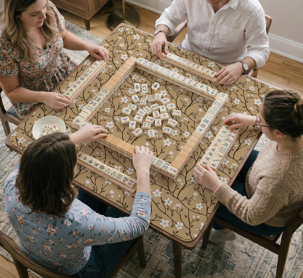 Beige mahjong mat with a white blossom branch floral pattern on a neutral background.