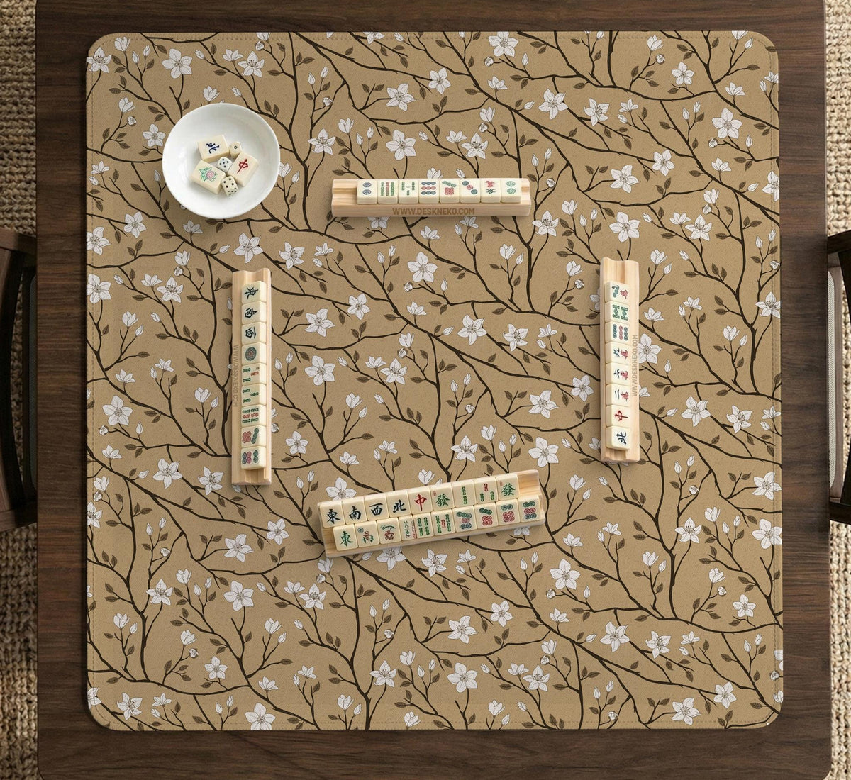 Beige mahjong mat with a white blossom branch floral pattern on a neutral background.