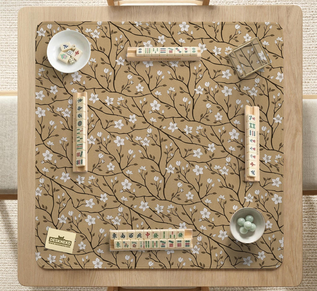 Beige mahjong mat with a white blossom branch floral pattern on a neutral background.