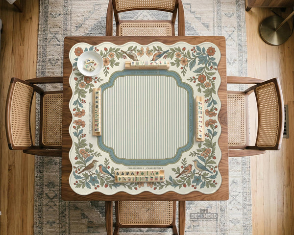 Square mahjong mat with a cream background, blue birds, sage leaves, terracotta flowers, and a decorative botanical border with printed rules text.