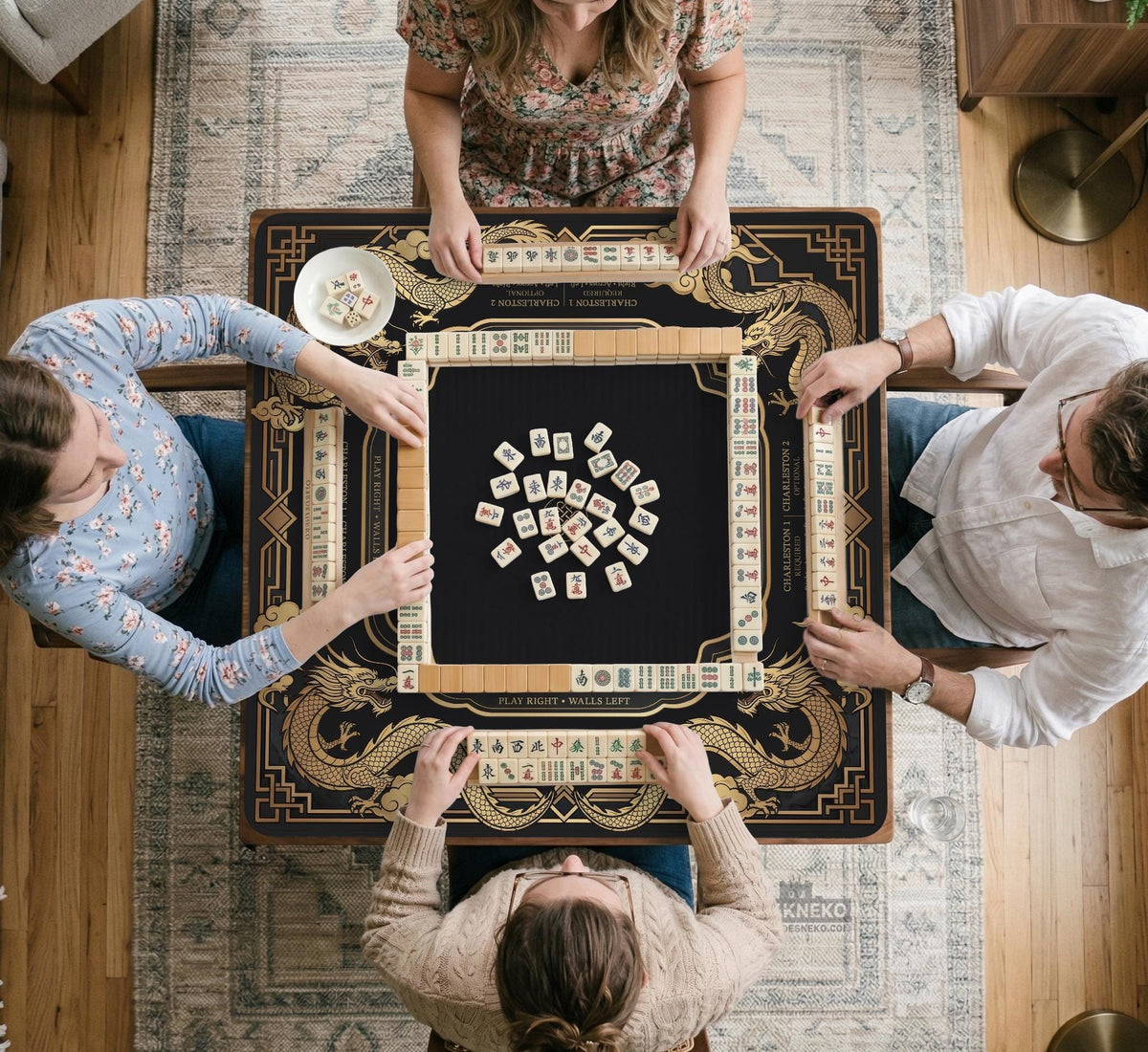 Black mahjong mat with gold dragon artwork, a scalloped edge, and printed Mahjong rules on the surface.