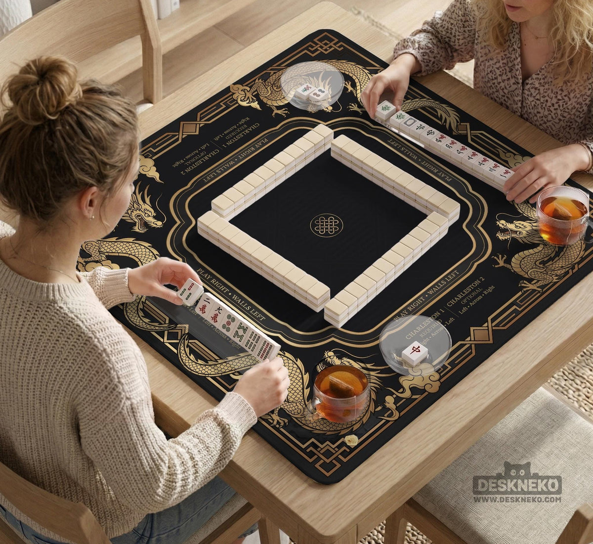 Black mahjong mat with gold dragon artwork, a scalloped edge, and printed Mahjong rules on the surface.