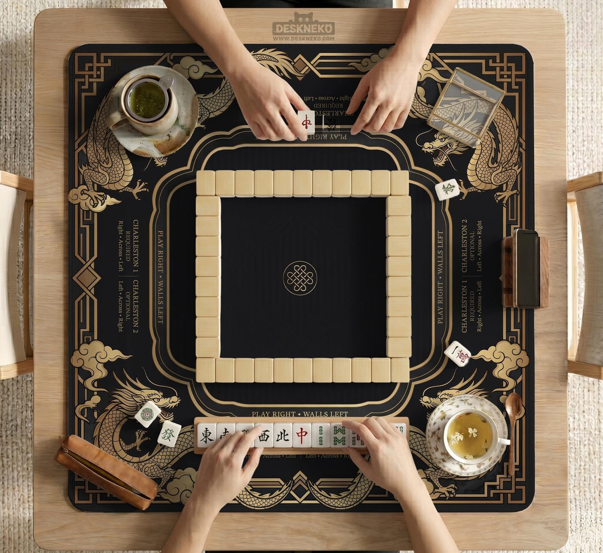 Black mahjong mat with gold dragon artwork, a scalloped edge, and printed Mahjong rules on the surface.
