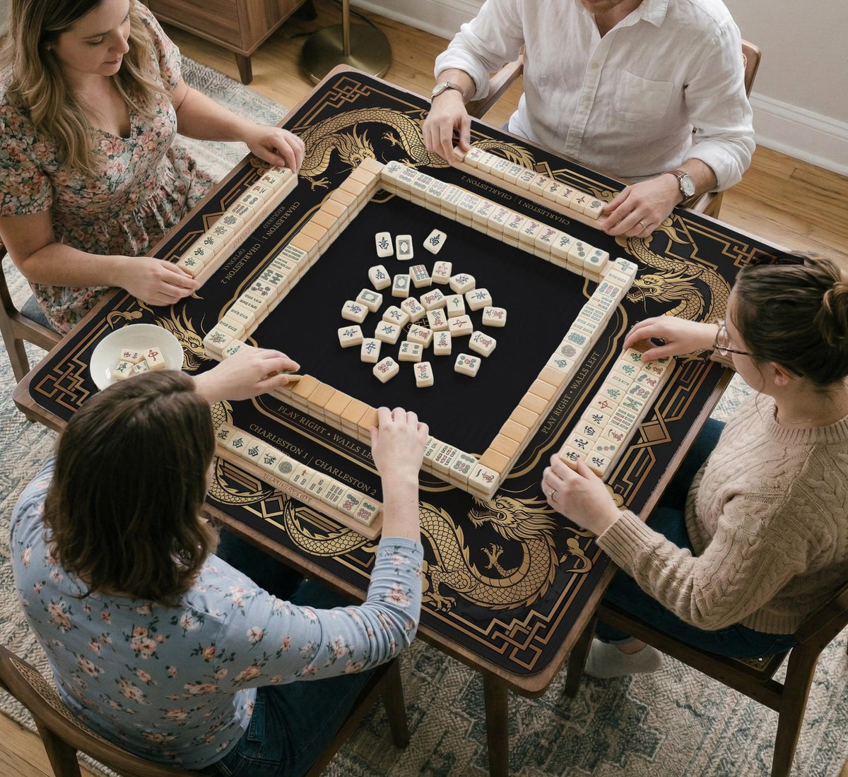 Black mahjong mat with gold dragon artwork, a scalloped edge, and printed Mahjong rules on the surface.