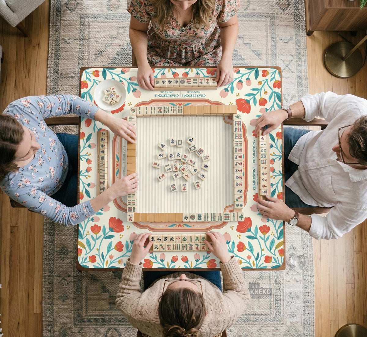Cream mahjong mat with a coral and teal floral border, rule layout text, Charleston guide notes, and a blank center area for tile play.
