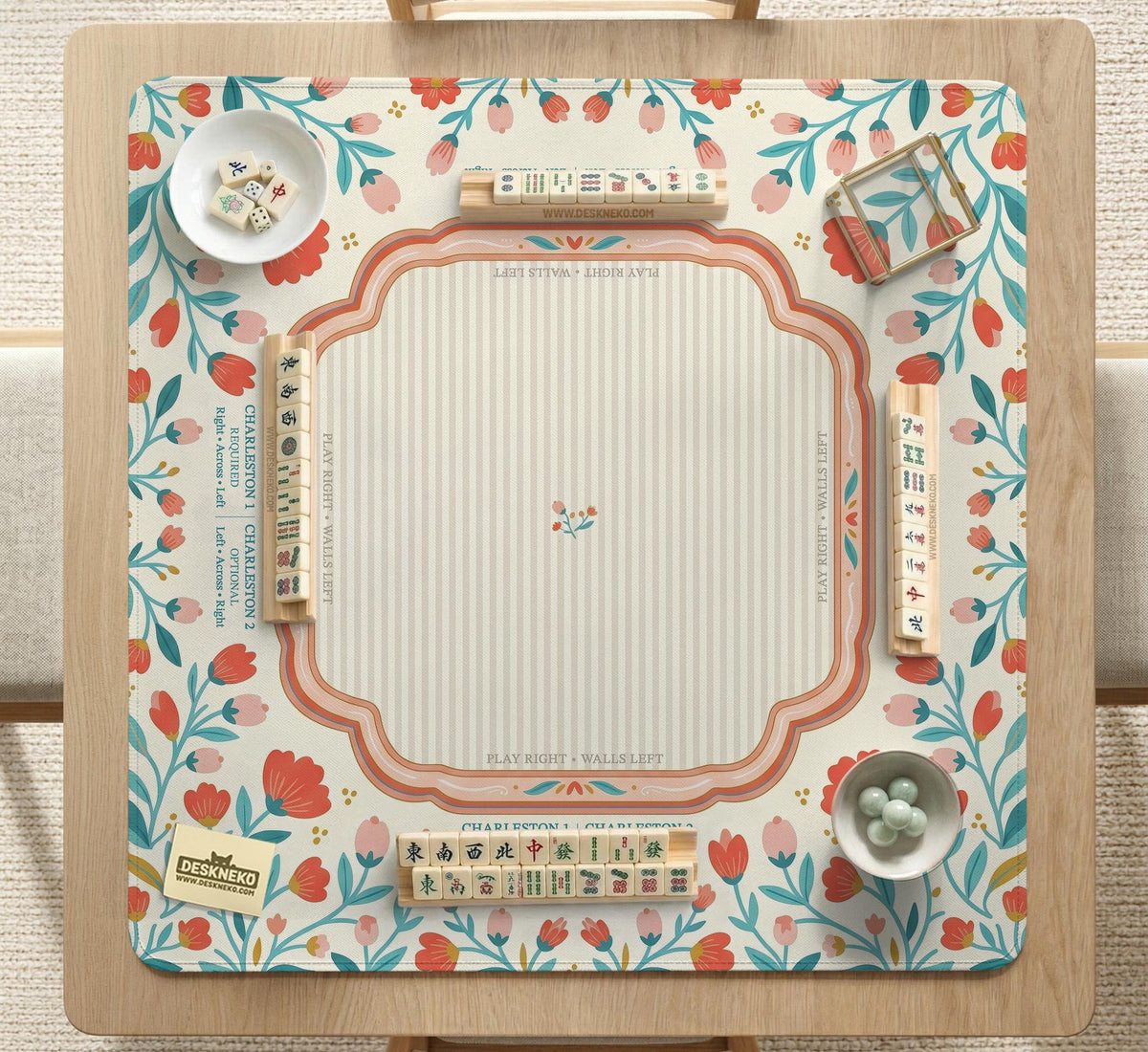 Cream mahjong mat with a coral and teal floral border, rule layout text, Charleston guide notes, and a blank center area for tile play.