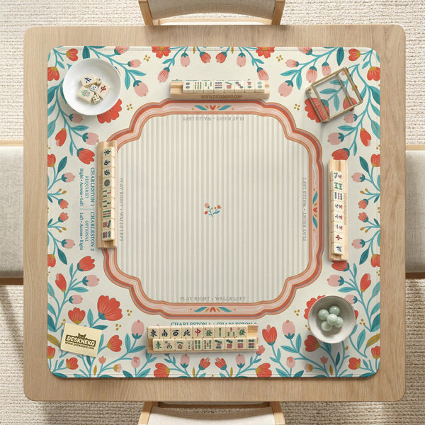 Cream mahjong mat with a coral and teal floral border, rule layout text, Charleston guide notes, and a blank center area for tile play.