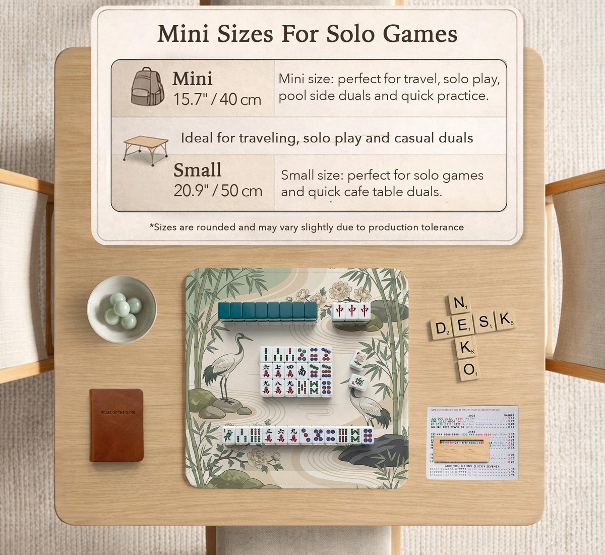 Square mahjong mat with a cream background, sage green cranes, bamboo leaves, peony branches, stones, and thin linework.