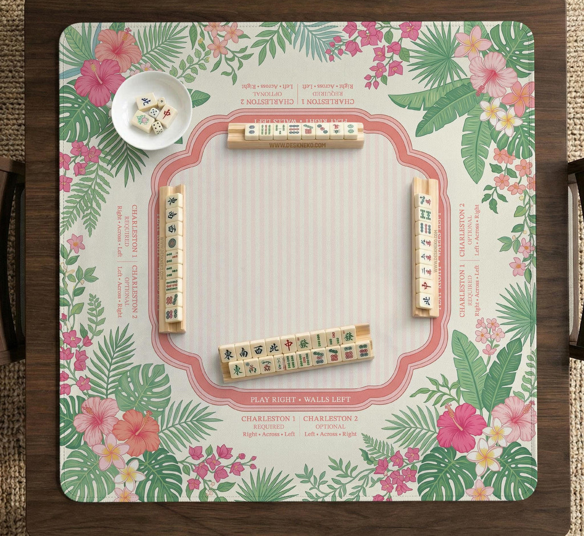 Coral tropical floral mahjong mat with hibiscus flowers, palm leaves, cream sections, and a scalloped edge.
