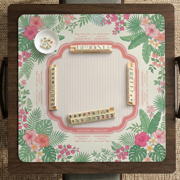 Coral tropical floral mahjong mat with hibiscus flowers, palm leaves, cream sections, and a scalloped edge.