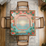 A square mahjong mat with flamingos, hibiscus flowers, palm leaves, and aqua water accents on a coral background with a scalloped edge.