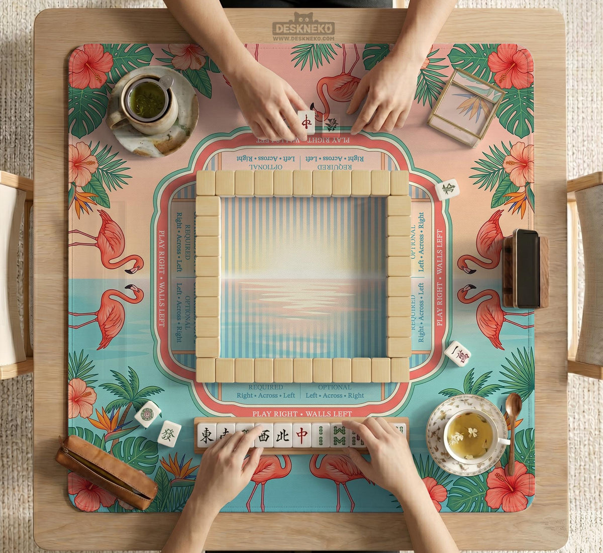 Pink mahjong mat with flamingos, palm leaves, hibiscus flowers, and aqua tropical background.