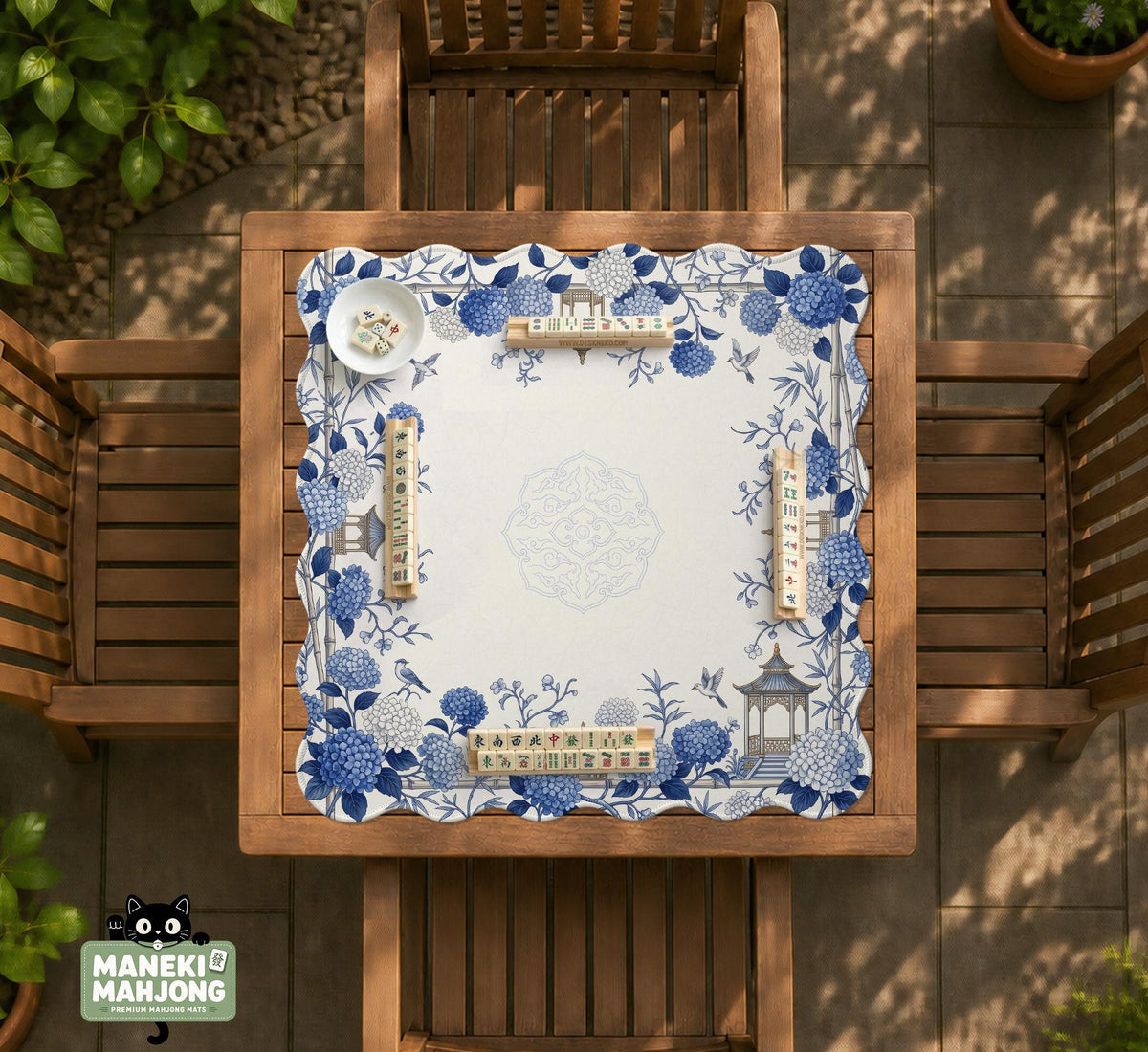 Blue and white square mahjong mat with a hydrangea and bird botanical border and a plain center area.