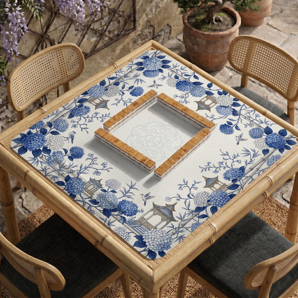 Blue and white square mahjong mat with a hydrangea and bird botanical border and a plain center area.