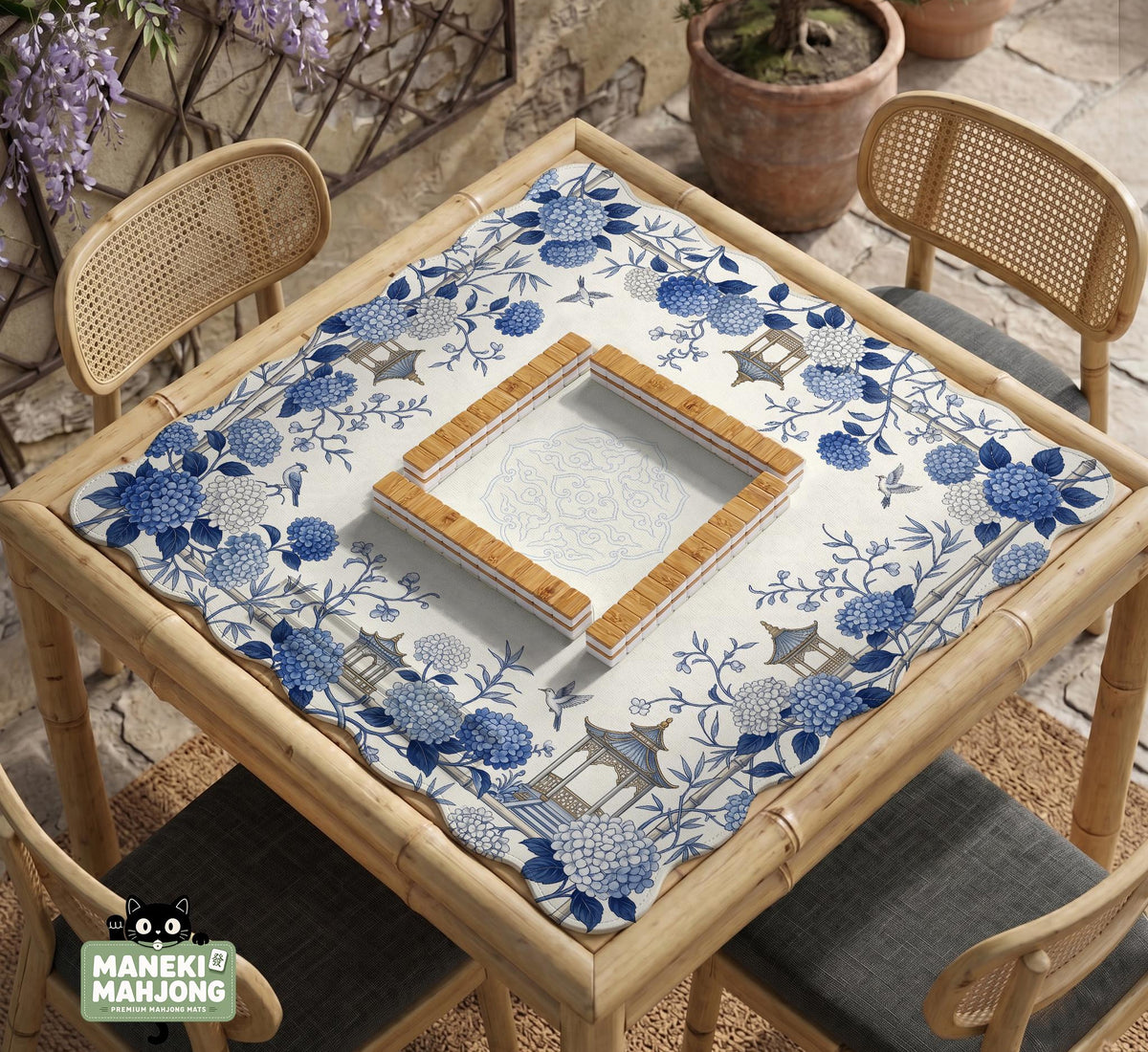Blue and white square mahjong mat with a hydrangea and bird botanical border and a plain center area.