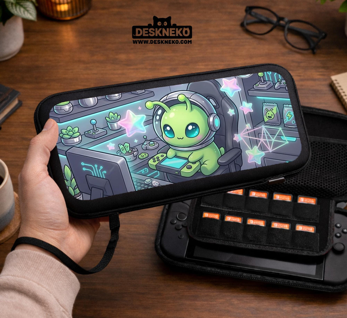 A Switch carrying case design with a cute green alien at a gaming desk, glowing cyan lights, and pastel stars on a dark background.