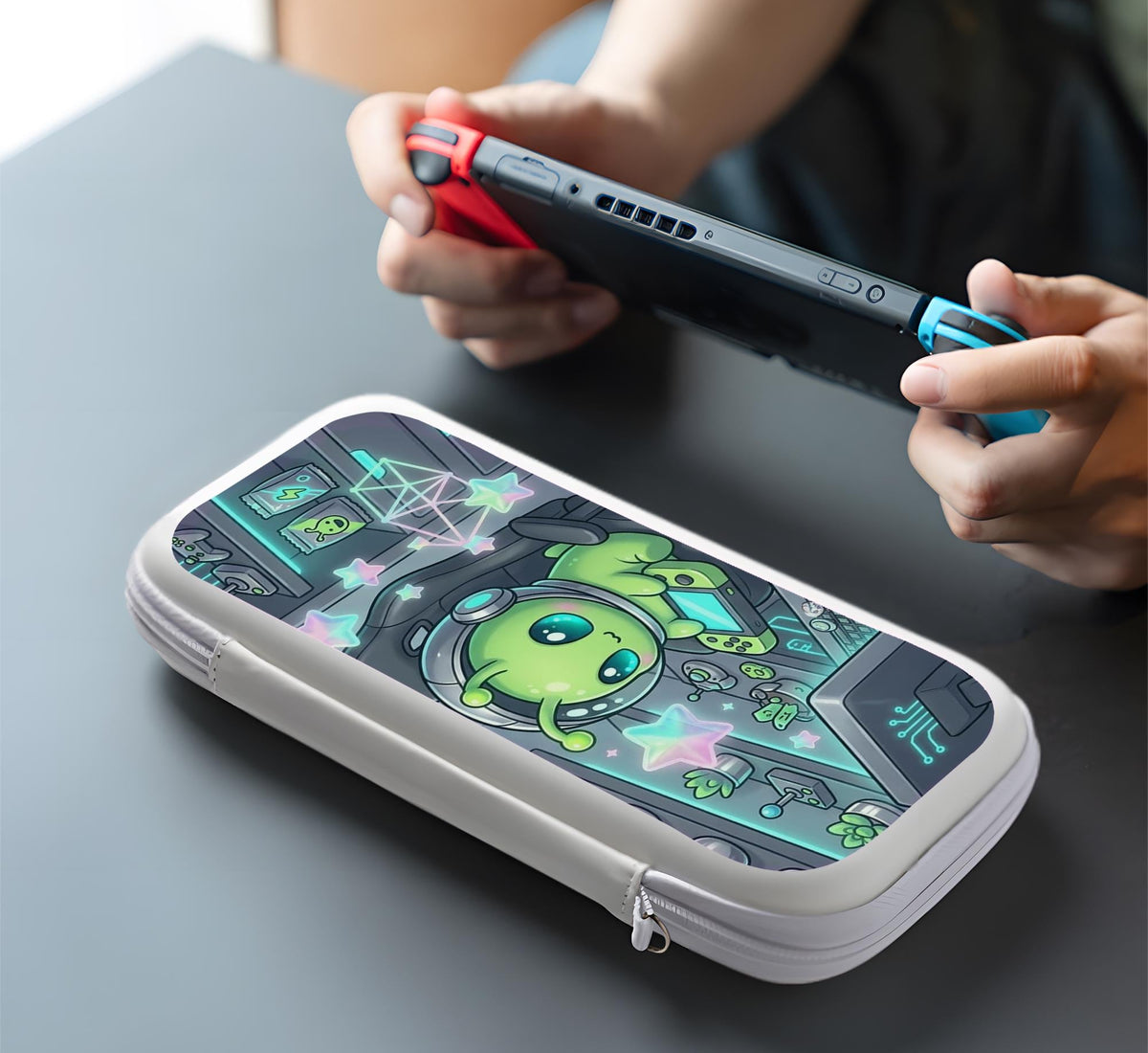 A Switch carrying case design with a cute green alien at a gaming desk, glowing cyan lights, and pastel stars on a dark background.