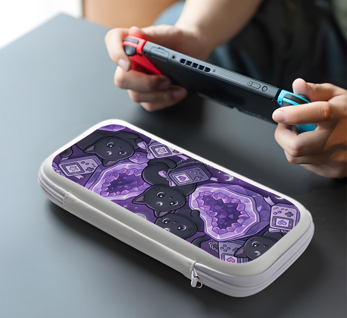 Purple carrying case with black cat faces, moon shapes, stars, and crystal geode style artwork for Nintendo Switch.