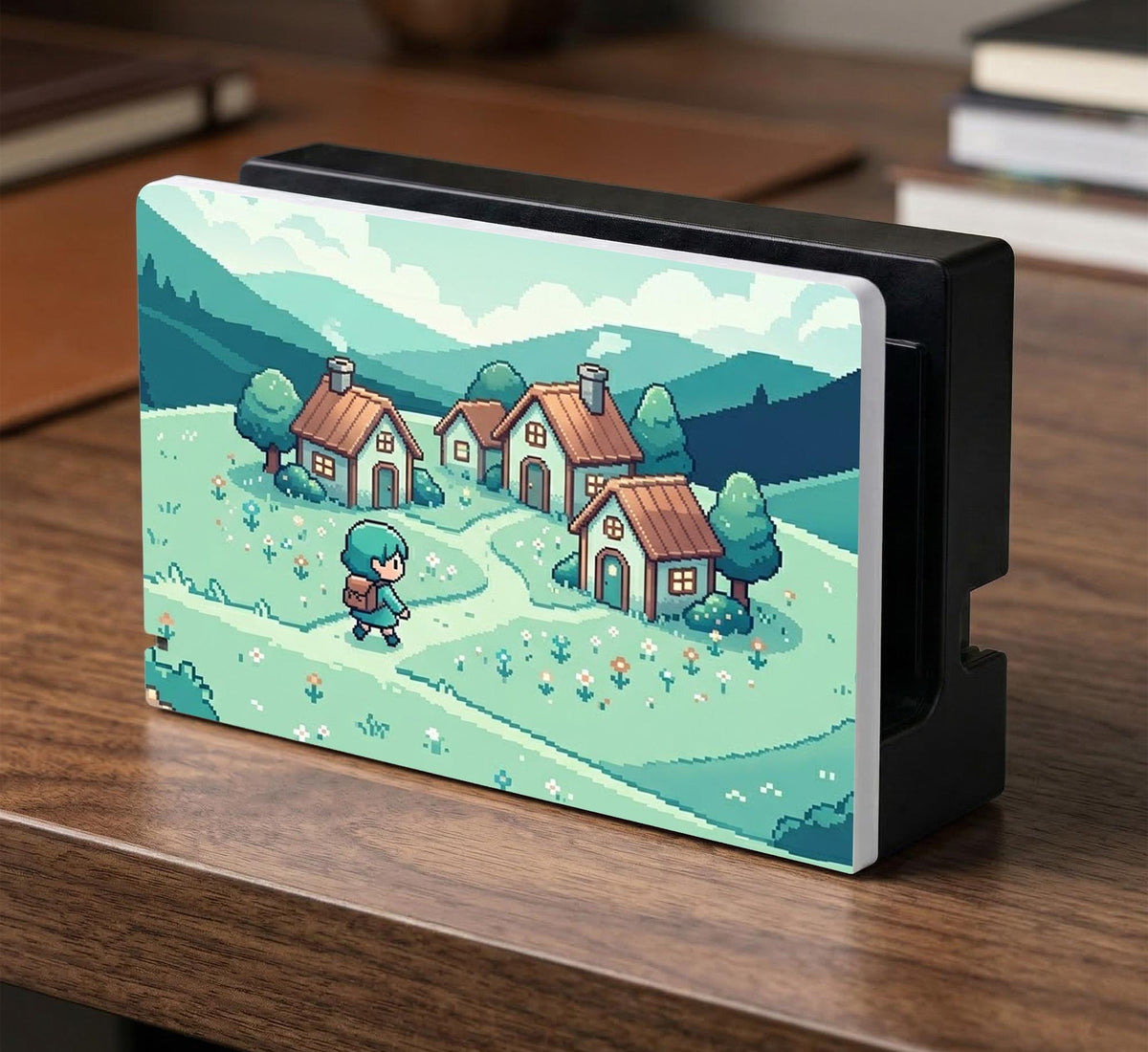 Teal carrying case with a pixel-style village scene, small houses, layered mountains, flowers, and a retro game-inspired landscape design.