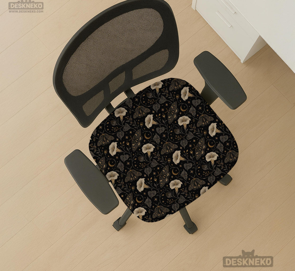 Black chair cover with a moth, moon, and flower pattern in gold, ivory, and dark botanical tones.