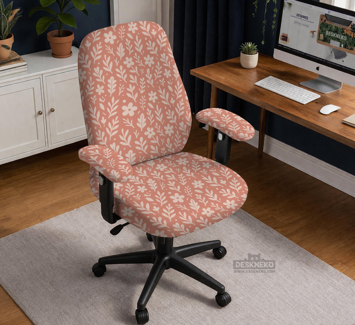 Pink chair cover with a botanical floral print shown on an office chair, with matching armrest covers and multiple cover style options.