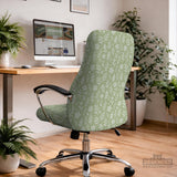 Green chair cover with a small botanical floral print in sage and cream.