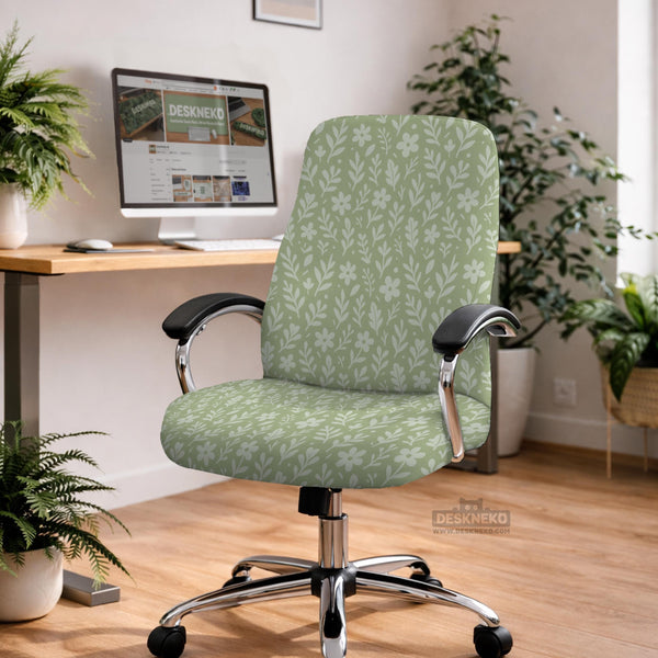 Green chair cover with a small botanical floral print in sage and cream.