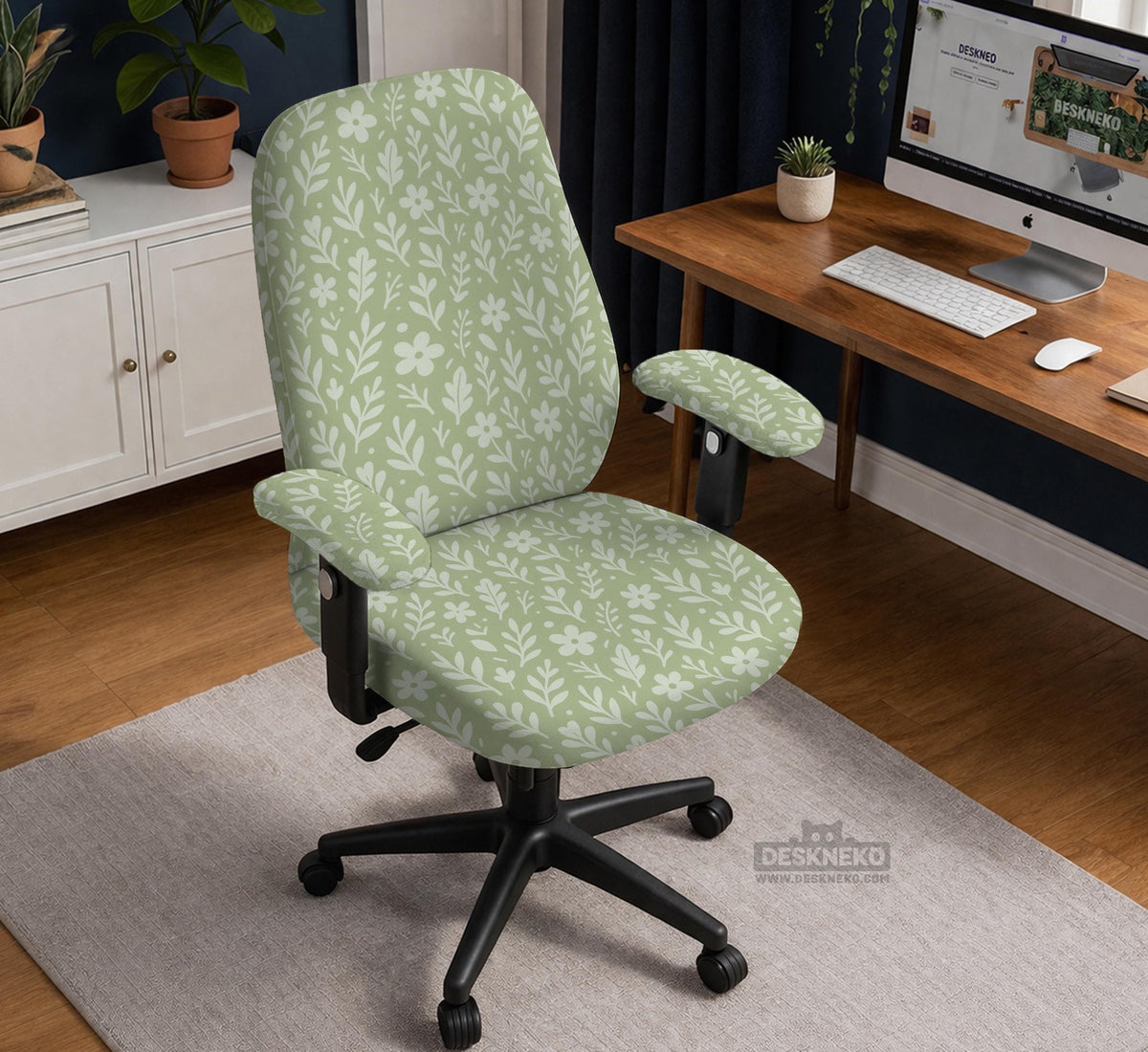 Sage green desk chair cover with a small floral and leaf print shown on an office chair.