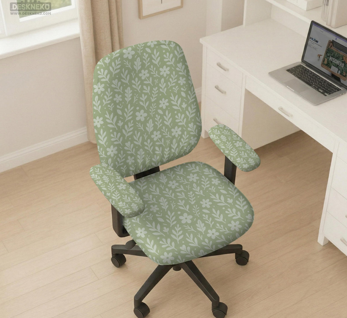 Sage green desk chair cover with a small floral and leaf print shown on an office chair.