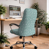 Sage and aqua green floral chair cover shown on a gaming chair with matching armrest covers.