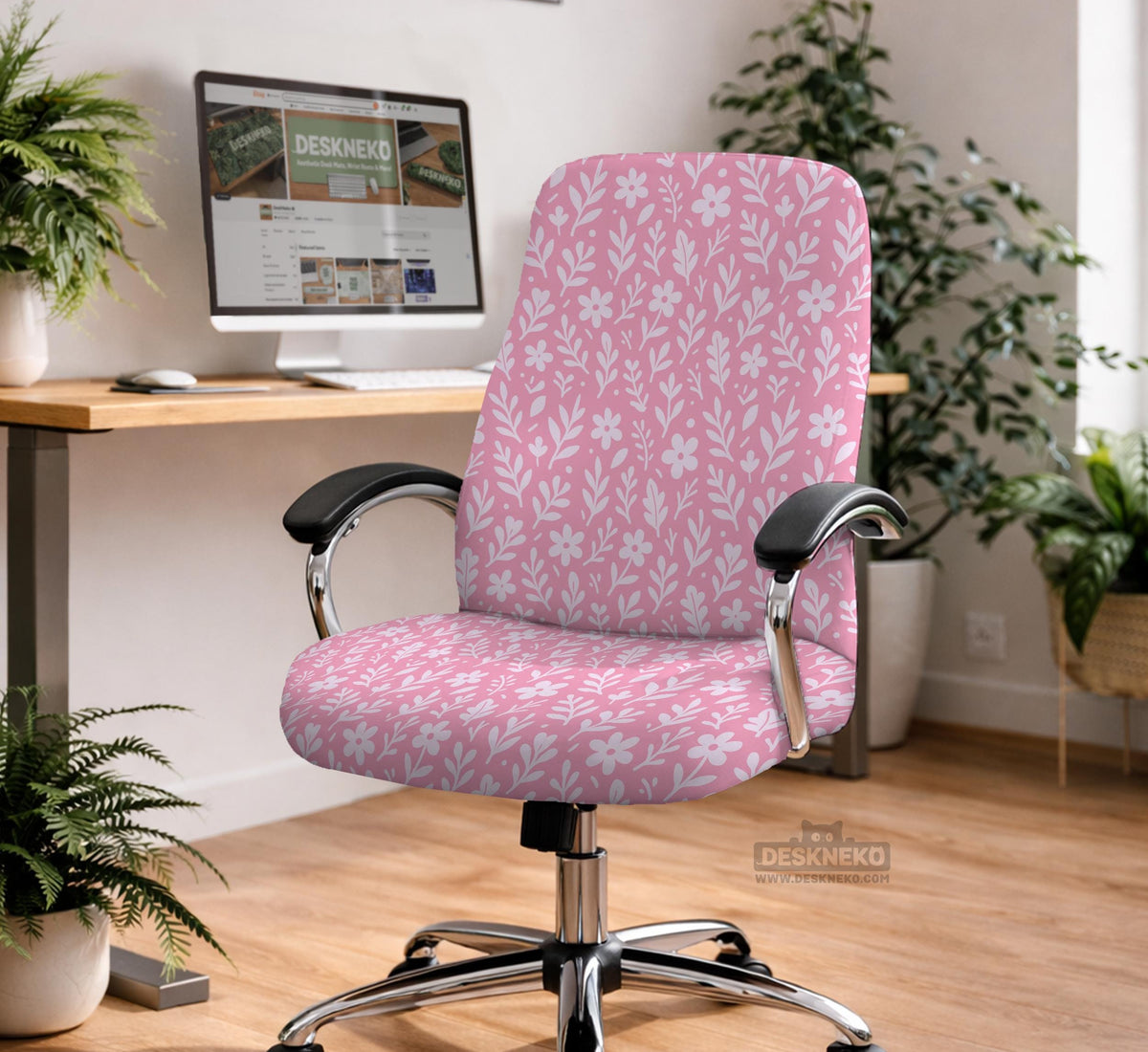 Soft pink floral chair cover shown on a gaming chair with a high back and armrests.