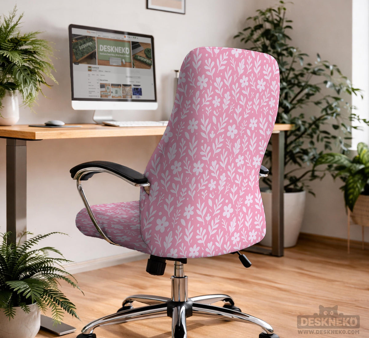 Soft pink floral chair cover shown on a gaming chair with a high back and armrests.