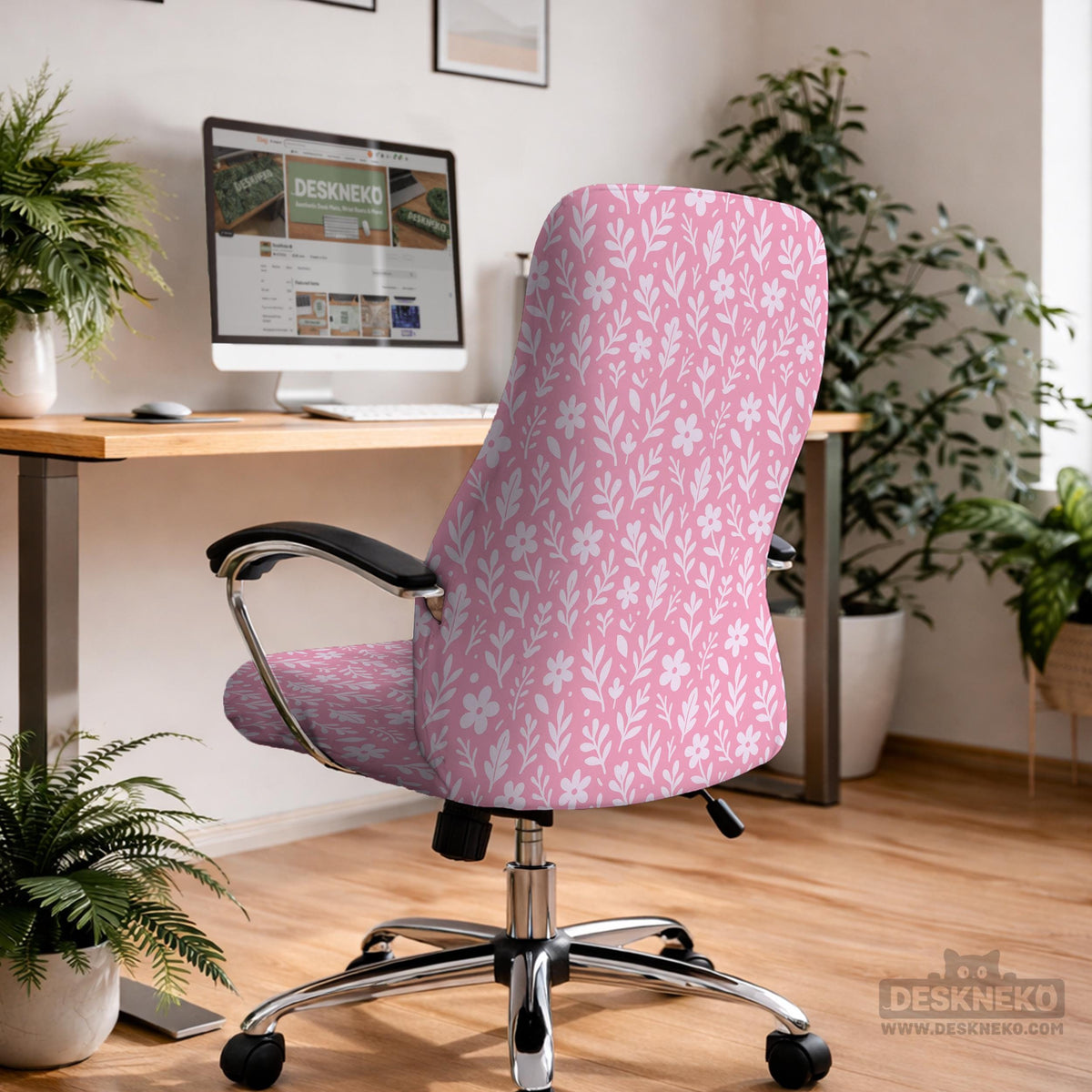Soft pink floral chair cover shown on a gaming chair with a high back and armrests.