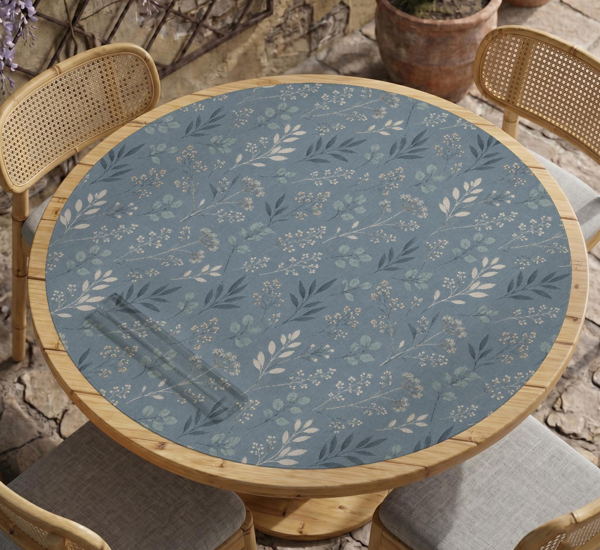 Blue mahjong mat with a botanical floral pattern, pale leaves, and delicate stems on a dusty blue background.