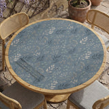 Blue mahjong mat with a botanical floral pattern, pale leaves, and delicate stems on a dusty blue background.